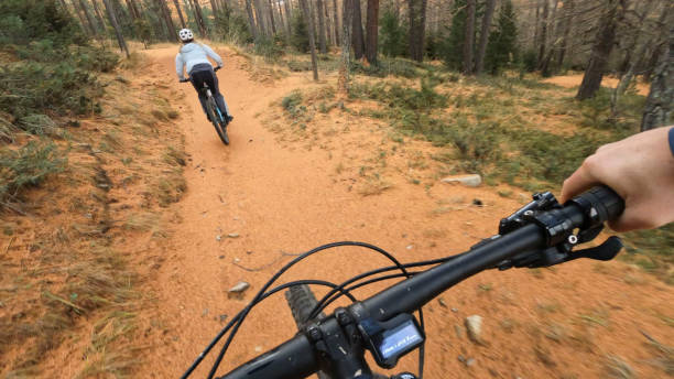 istock POV to mountain biker riding trail in autumn forest 2183097125
