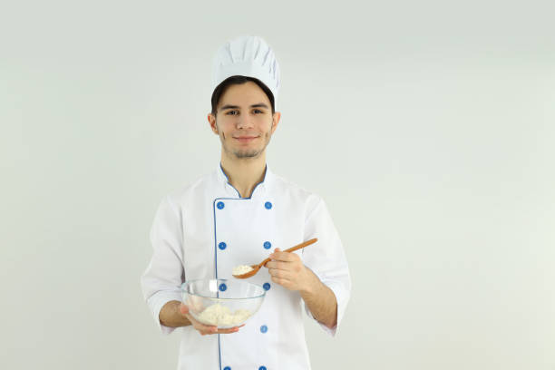 istock Concept of cooking, young man chef on light background 2183098305