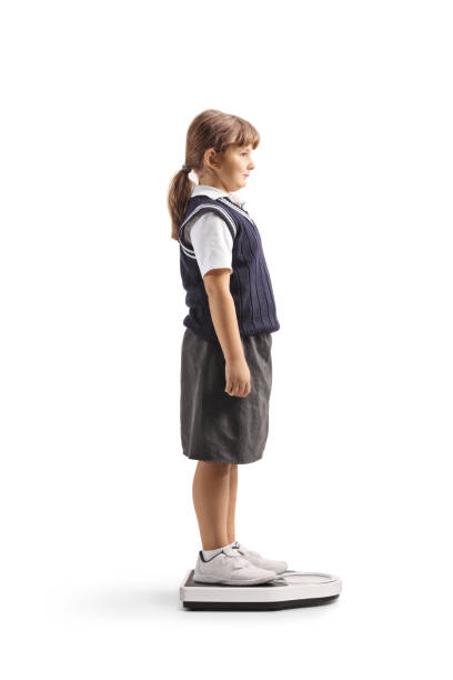 School kid at a routing doctor check, weight measure isolated on white background