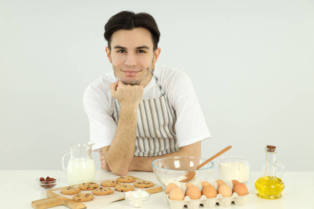 istock Concept of cooking, young man chef on light background 2183098641