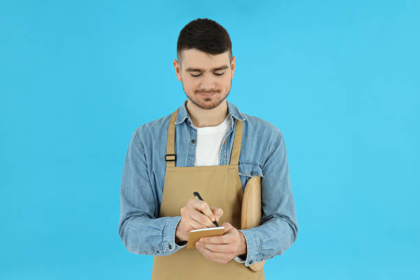 istock Concept of occupation, young waiter on blue background 2183101222
