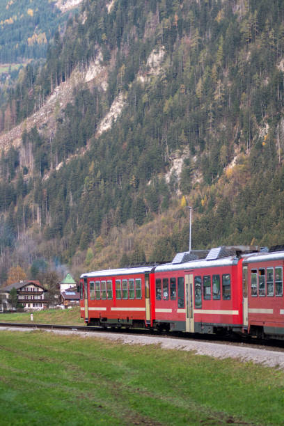 Alpine train in the mountains. Austrian alps train. Public transportation in nature.