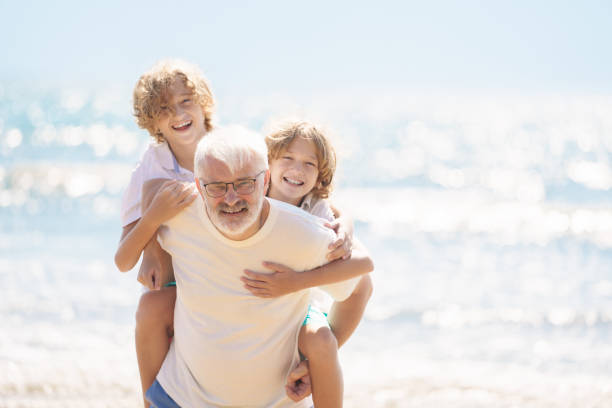 istock Grandfather and kids on summer beach 2183101488