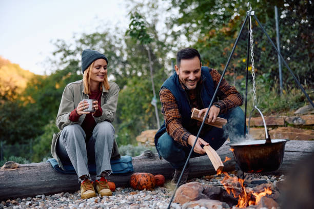 istock Happy couple cooking during autumn camping in nature. 2183101603