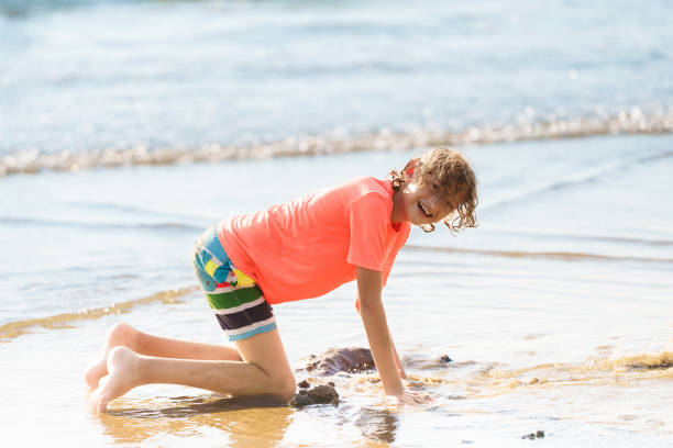 istock Kids playing on beach. Children play at sea. 2183101785