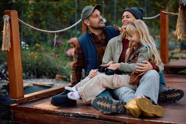 istock Carefree family talking while relaxing on a pier during autumn day. 2183101938