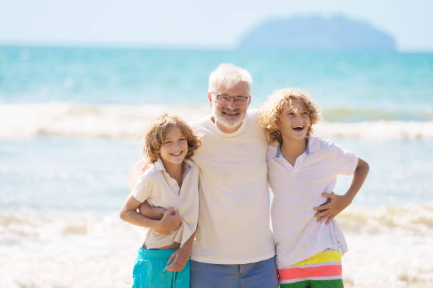 istock Grandfather and kids on summer beach 2183102047