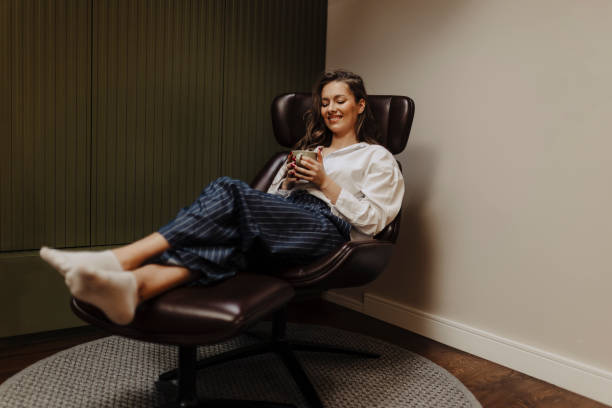 istock Woman drinking coffee and resting at home 2183103928