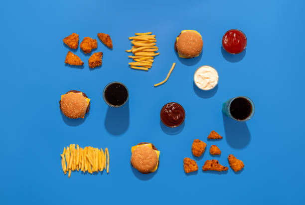 istock Fast food meals and drinks, above view, isolated on a blue background. 2183105108