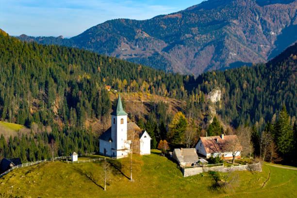 Slovenia, Solcava. Aerial view of Church Sveti Duh in Kamnik-Savinja Alps region on a sunny autumn day