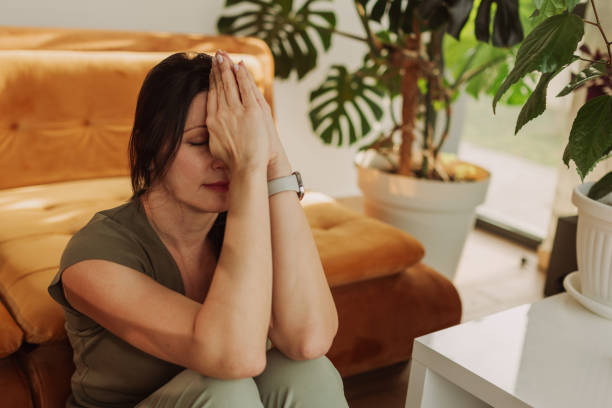 Woman Practicing Mindfulness Meditation at Home with Plants
