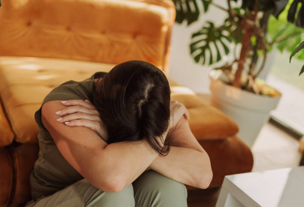 istock Woman Sitting Alone in Living Room Feeling Overwhelmed 2183114152