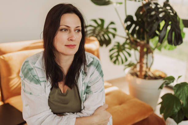 istock Calm Woman Relaxing on a Cozy Sofa at Home 2183114173