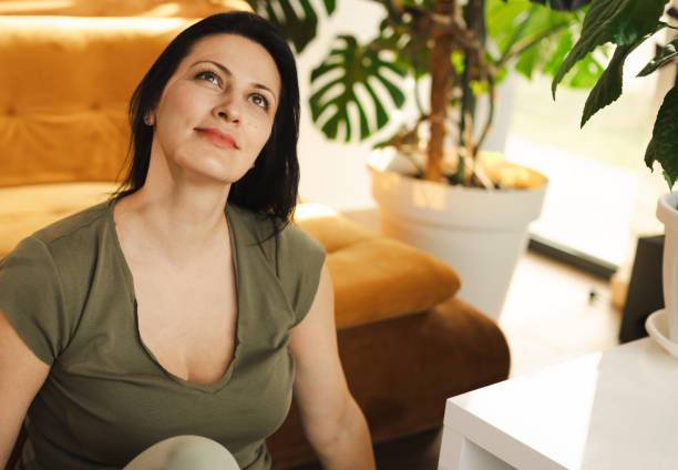 istock Thoughtful Woman Relaxing in Cozy Living Room Setting 2183114175