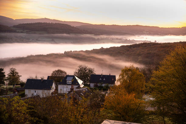 Autumn landscape in Burgundy at Château-Chinon in France, with forests, hills and houses at sunrise