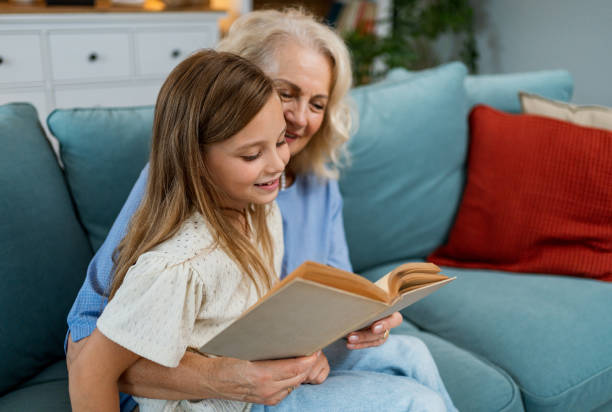 istock Grandmother with granddaughter reading book 2183117380