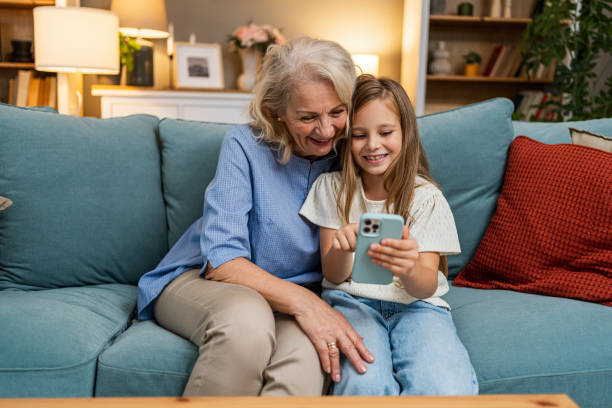 istock Grandma and granddaughter using phone together 2183117494