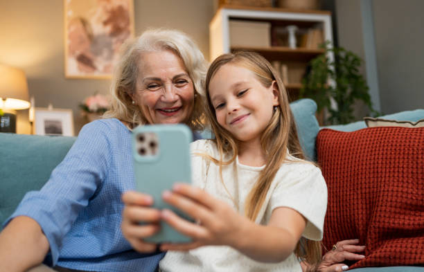 istock Grandmother and granddaughter taking selfies 2183117617
