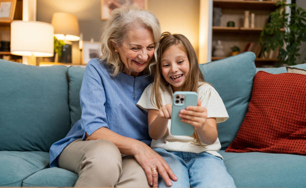 istock Grandma and granddaughter using phone together 2183117638