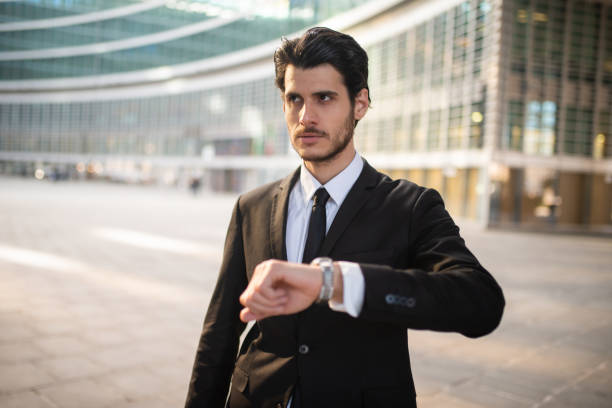 istock Businessman checking time outside office building 2183118341