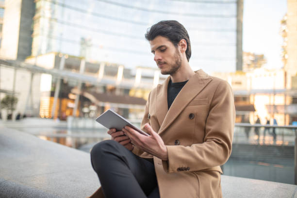 istock Businessman using digital tablet in city center 2183118581