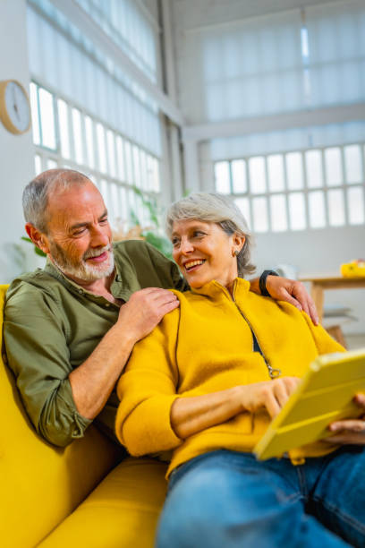 istock Senior couple relaxed at home using digital tablet together 2183118626