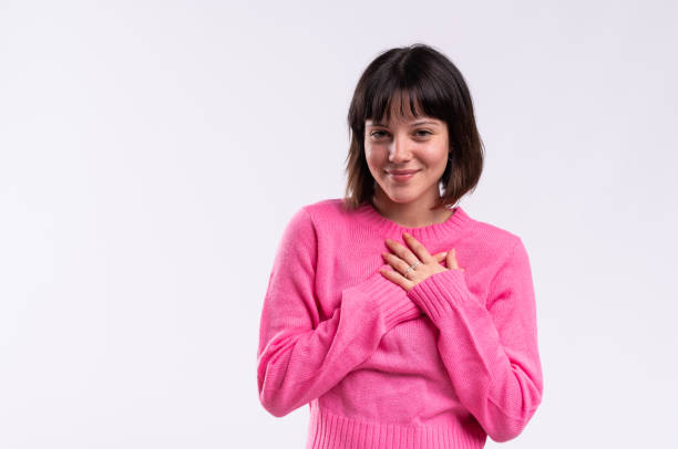 istock Young woman expressing gratitude and hope with hands on chest 2183120742