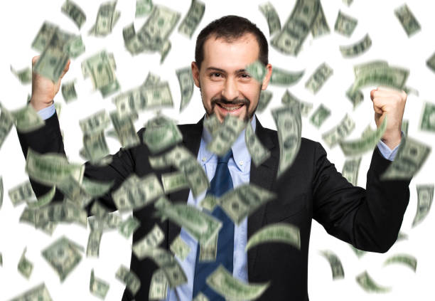 istock Happy businessman celebrating with falling dollar bills 2183121876