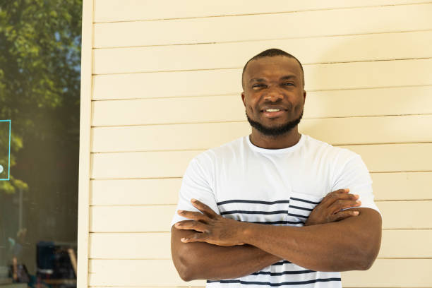 istock A young African-American man poses for the camera against a wall background 2183122513