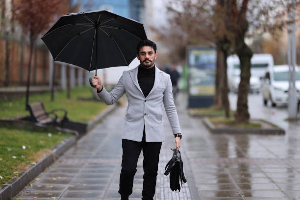 Businessman in rain in city
