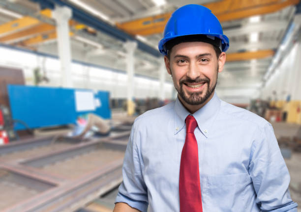 istock Smiling engineer wearing a hard hat in a factory 2183123545