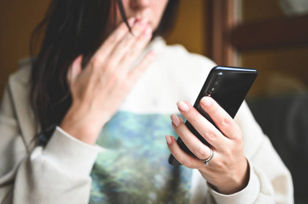 istock woman looking at call from unknown number. 2183124818