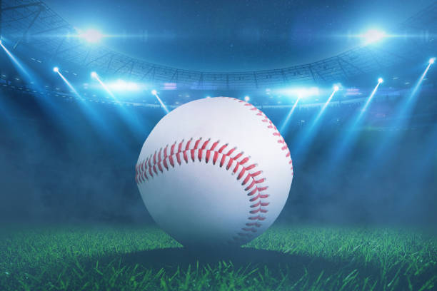 istock baseball ball lying on grass during tournament at stadium with floodlights. Baseball championship, creative idea 2183127981