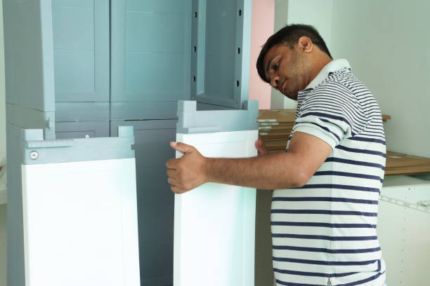 istock Image of man building modular furniture, assembling plastic storage unit, wardrobe setup in minimalist white and gray design, DIY home renovation 2183128226
