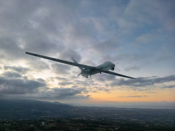istock Military drone flying in the cloudy air, UAV 2183129714