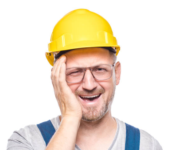 istock Joke. Laughing construction worker looking through his fingers and laughs at you, isolated on white background. Playful amused repairman. Craftsman against white wall 2183131739
