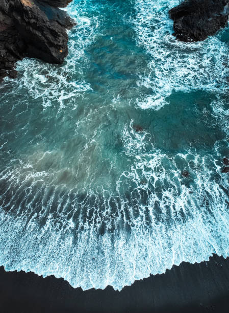 istock Atlantic ocean from above, waves and black basalt sand and rocks, view f 2183134358