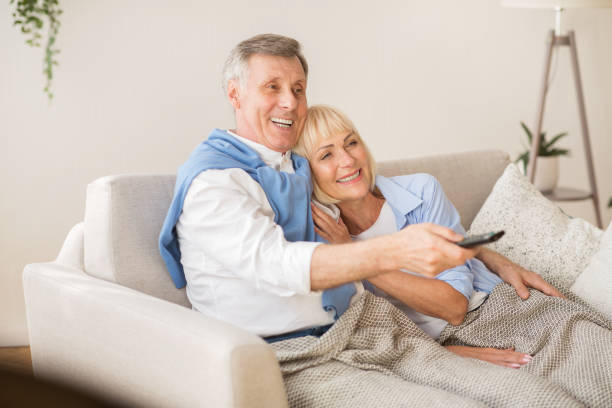 istock Relaxed senior couple watching television at home 2183135096