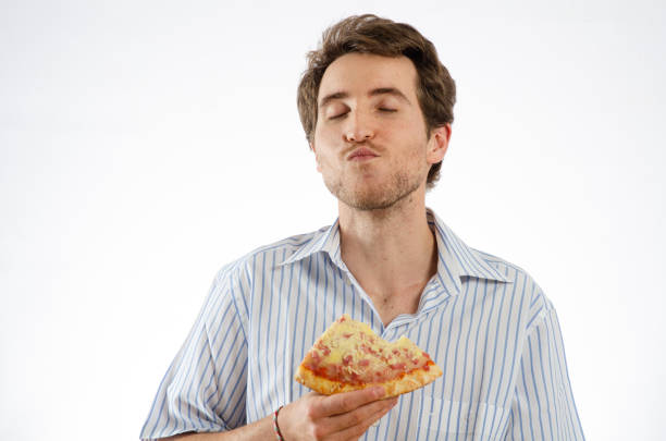 istock A man enjoys eating pizza. Isolated white background for text space 2183142698