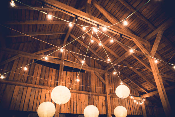 istock Cozy barn with lanterns and string lights, perfect for an evening celebration 2183143474