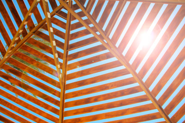 Sunbeam makes its way through wooden roof of canopy on beach. Travel concept. Tropical recreation. Vacations in tropics. Lifestyle concept. Relaxing concept