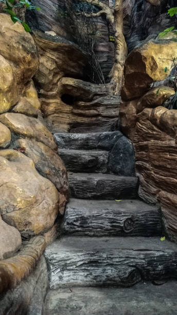istock artificial stairs leading up to a small cave 2183144892