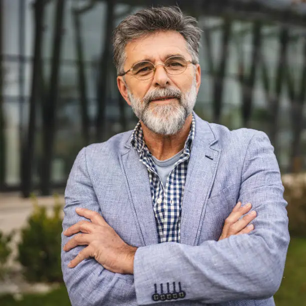 Portrait of senior man businessman arm crossed outdoor Portrait of senior man businessman arm crossed outdoor