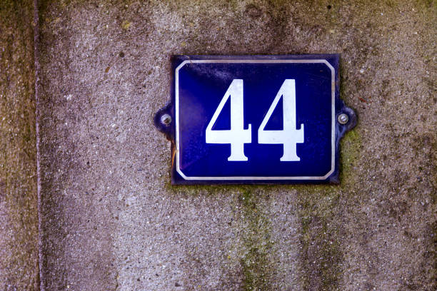 istock Metal panel with the number 44 on a wall 2183145238
