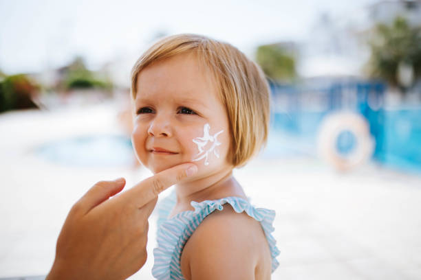 istock Mother applying sunscreen to her daughters face 2183146844