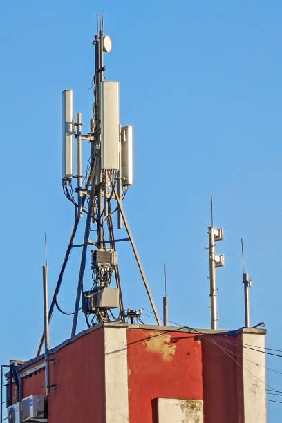 istock Tall cell tower stands out against clear blue sky, its center dominated by multi-antenna structure 2183147197