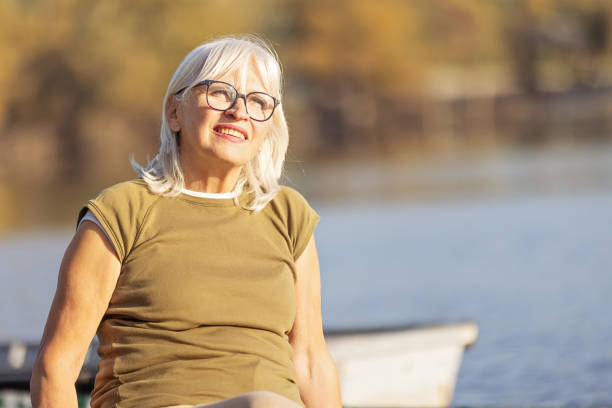 istock Relaxed Senior Woman Enjoying Time by the Lakeside 2183147938