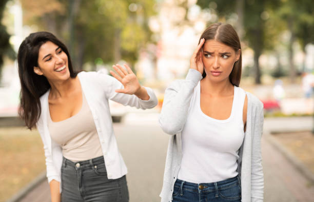 istock Shy Girl Avoiding Meeting Friend Having Communication Problems Walking Outdoors 2183148383