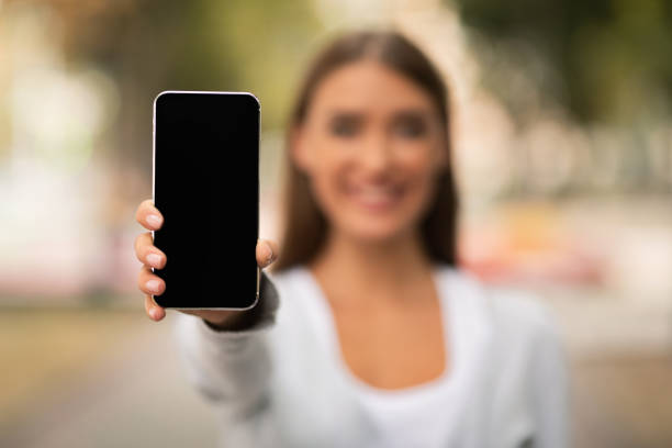 istock Unrecognizable Woman Showing Cellphone Empty Screen Standing Outdoor, Mockup 2183148529