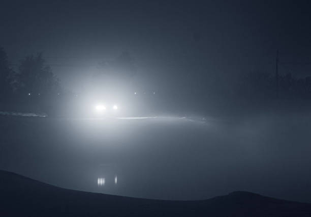 istock a car with fog lights on at night, when driving is impossible and dangerous with poor visibility, against the background of the night sky and slippery roads in winter on ice 2183153798